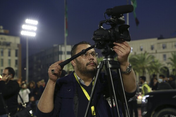 Libya video producer for The Associated Press Adel Omran films an event marking Libyan’s Independence Day on December 24, 2021 in Tripoli, Libya. Omran died Friday, Oct. 27, 2023 at 46 years old after suffering a heart attack in Port Said, Egypt. Omran led AP's video coverage of the uprising that turned into a prolonged civil war in Libya. He is remembered by many as a talented and caring colleague. (AP Photo/Yousef Murad)