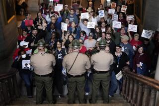 FILE - Tennessee State Troopers block the stairwell leading to the legislative chambers Thursday, April 6, 2023, in Nashville, Tenn. Two young Black Tennessee state legislatorJustin Pearson and Justin Jones — now widely known simply as "the Justins" — were expelled by the overwhelmingly white, Republican-controlled state Legislature and then reinstated by local officials days later. They are being heralded as living echoes of the civil rights struggles of the 1960s, when leaders like the Rev. Martin Luther King Jr., John Lewis and A. Philip Randolph organized protests across the American South. (AP Photo/George Walker IV, File)