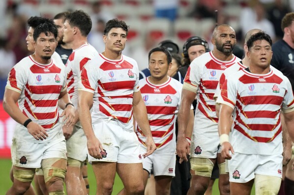 Japanese players react after the end of the Rugby World Cup Pool D match between England and Japan in the Stade de Nice, in Nice, France Sunday, Sept. 17, 2023. England won the game 34-12. (AP Photo/Pavel Golovkin)