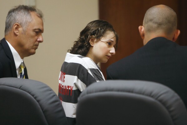 FILE - Gypsy Rose Blanchard speaks with her attorney's Mike Stanfield, right, and Clate Baker before her court appearance, July 5, 2016, in Springfield, Mo. Blanchard, the Missouri woman who admitted to convincing her online boyfriend to kill her abusive mother after being forced to pretend for years she was suffering from leukemia, muscular dystrophy and other serious illnesses, is set to be paroled Thursday, Dec. 28, 2023. (Andrew Jansen/The Springfield News-Leader via AP, File)