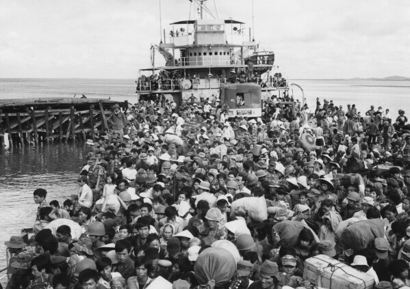 FILE - Refugees crowd a naval vessel docked at Vung Tau, a coastal town near Saigon on April 9, 1975. The Immigration and Nationality Act of 1952 lets the president grant entry for humanitarian reasons and matters of public interest. Previous administrations have admitted large numbers of Hungarians, Vietnamese and Cubans. (AP Photo/Kim Ki Sam, File)