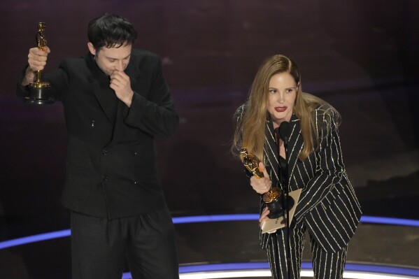 Arthur Harari, left, and Justine Triet accept the award for best original screenplay for "Anatomy of a Fall" during the Oscars on Sunday, March 10, 2024, at the Dolby Theatre in Los Angeles. (AP Photo/Chris Pizzello)