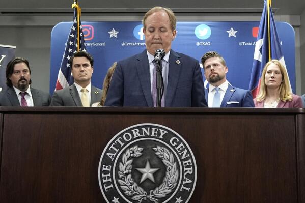 Texas state Attorney General Ken Paxton, center, flanked by his staff, makes a statement at his office in Austin, Texas, Friday, May 26, 2023. An investigating committee says the Texas House of Representatives will vote Saturday on whether to impeach state Attorney General Ken Paxton. (AP Photo/Eric Gay)