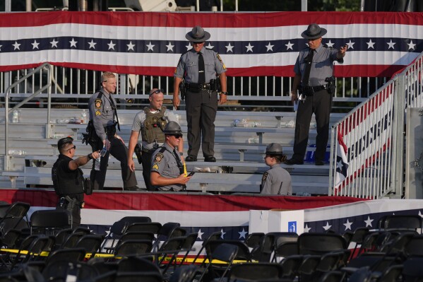 Law enforcement officers gather at the campaign rally site for Republican presidential candidate former President Donald Trump Saturday, July 13, 2024, in Butler, Pa. Trump's campaign said in a statement that the former president was "fine" after a shooting at his rally in Butler (ĢӰԺ Photo/Evan Vucci)