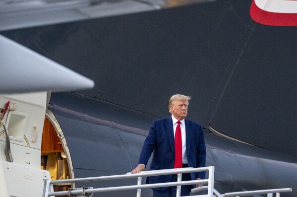 Former President Donald Trump boards his plane after speaking with reporters before departure from Hartsfield-Jackson Atlanta International Airport, Thursday, Aug. 24, 2023, in Atlanta. (AP Photo/Alex Brandon)