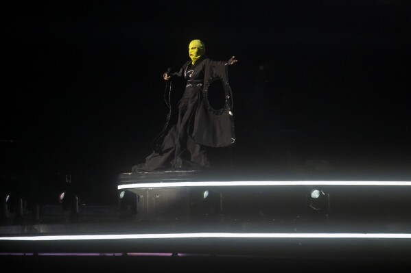 Madonna rehearses in a mask for her Celebration tour in Rio de Janeiro, Brazil, Thursday, May 2, 2024. Madonna, who removed her mask at the end of rehearsal, will conclude her tour on Saturday with a free concert at Copacabana Beach. (AP Photo/Bruna Prado