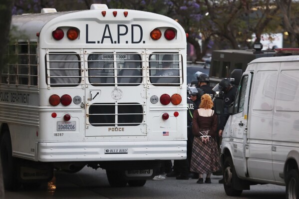 Protesters are loaded onto Los Angeles Police Department buses during a protest on Wednesday, June 11, 2025, in Los Angeles. (AP Photo/Ethan Swope)