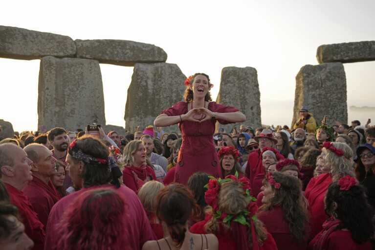 Revelers gather at the ancient stone circle Stonehenge to celebrate the Summer Solstice, the longest day of the year, near Salisbury, England, Wednesday, June 21, 2023. (AP Photo/Kin Cheung)