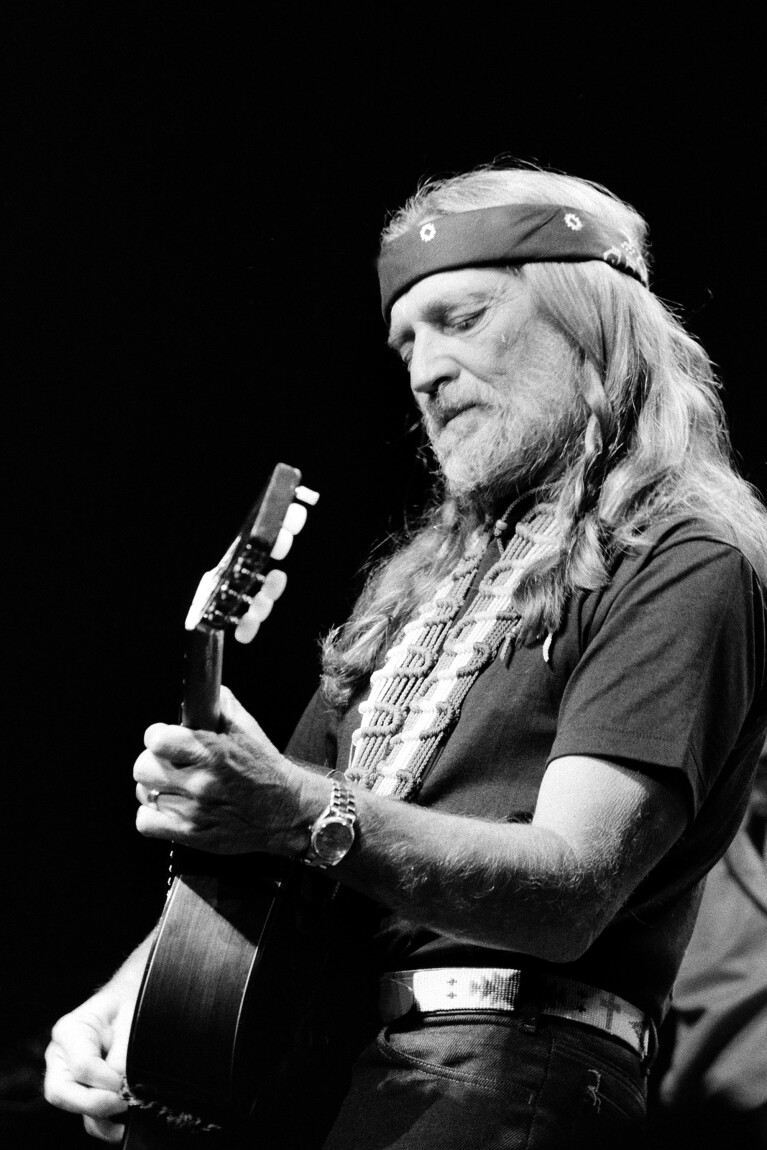 FILE - Willie Nelson performs at New York's Radio City Music Hall Thursday night in the first of six sold-out concerts, May 25, 1984. The country legend's new book, “Energy Follows Thought,” gives the stories behind his most famous songs. (AP Photo/Richard Drew, File)