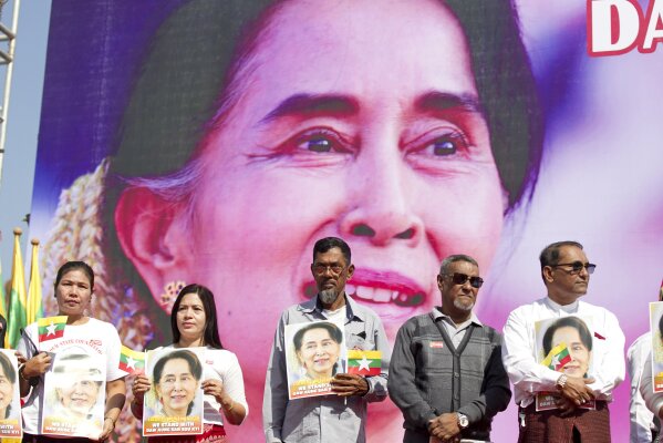 FILE - In this Tuesday, Dec. 10, 2019 file photo, Members of Myanmar Muslims community hold portraits of Myanmar leader Aung San Suu Kyi to pray as they gather in front of City Hall in Yangon, Myanmar. The U.N. General Assembly approved a resolution Friday, Dec. 27, 2019 strongly condemning human rights abuses against Myanmar’s Rohingya Muslims and other minorities, including arbitrary arrests, torture, rape and deaths in detention. (AP Photo/Thein Zaw, File)