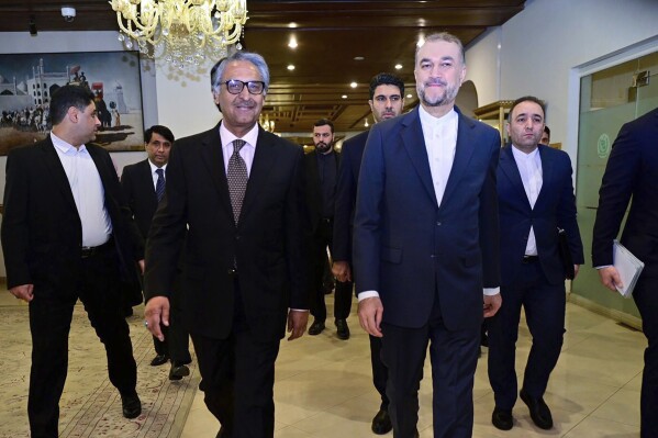 In this photo released by Pakistan's Ministry of Foreign Affairs, visiting Iran's Foreign Minister Hossein Amirabdollahian, front right, walks with his Pakistani counterpart Jalil Abbas Jilani, front left, upon his arrival for a meeting at the Ministry of Foreign Affairs in Islamabad, Pakistan, Monday, Jan. 29, 2024. Iran's foreign minister was in Pakistan for talks on deescalating tensions after deadly airstrikes by Tehran and Islamabad earlier this month killed at least 11 people, marking a significant escalation in fraught relations between the neighbors. (Ministry of Foreign Affairs via AP)