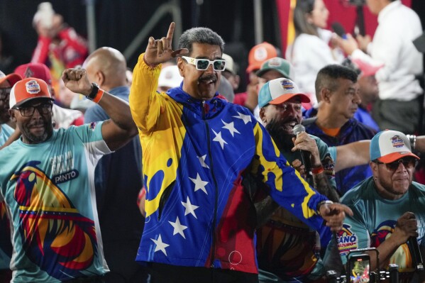 President Nicolas Maduro dances outside the Miraflores presidential palace after electoral authorities declared him the winner of the presidential election in Caracas, Venezuela, Monday, July 29, 2024. (AP Photo/Fernando Vergara)