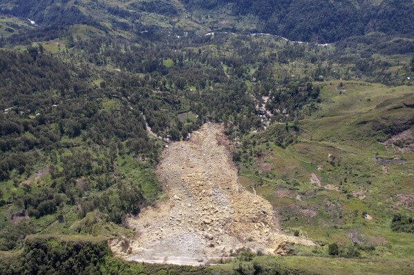 CORRECTS DATE - In this image taken from video, drone footage shows the landslide in Yambali village, in the Highlands of Papua New Guinea, Monday, May 27, , 2024. Emergency responders say that up to 8,000 people might need to be evacuated as the mass of boulders, earth and splintered trees that crushed the village of Yambali in the nation's mountainous interior on Friday, May 24 becomes increasingly unstable. (Juho Valta/UNDP Papua New Guinea via AP)