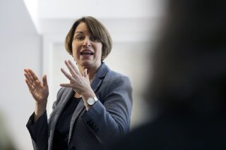 
              In this Sunday, Feb. 24, 2019, photo, U.S. Sen. Amy Klobuchar, D-Minn., speaks to voters during a campaign stop at a home in Nashua, N.H. U.S. Sen. and presidential hopeful Klobuchar has built a reputation as an effective champion for consumer safety. She also aggressively advocated for the medical device industry - a big employer in her home state of Minnesota - in ways that complicate her reputation as a consumer defender. Some consumer advocates say her work has helped put patients at risk. (AP Photo/Steven Senne)
            