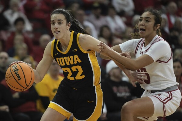 Iowa's Caitlin Clark drives past Wisconsin's Sania Copeland during the first half of a women's NCAA college basketball game Sunday, Dec. 10, 2023, in Madison, Wis. (APPhoto/Morry Gash)