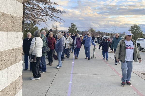 People wait in line to enter the caucus site at Spanish Springs Elementary School in Sparks, Nev., Thursday, Feb. 8, 2024. (APPhoto/Gabe Stern)