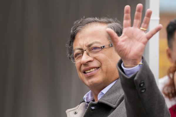 Gustavo Petro, presidential candidate with the Historical Pact coalition, waves upon his arrival to vote in a presidential runoff in Bogota, Colombia, Sunday, June 19, 2022. (AP Photo/Fernando Vergara)