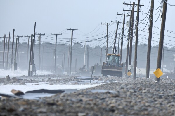 FILE - The remnants of East Beach Road are damaged after heavy overnight winds and surf battered the coastline, Wednesday, Jan. 10, 2024 in Westport, Mass. Salisbury, Mass., is scrambling after a weekend storm washed away mountains of sand trucked in for nearly $600,000 dune that was meant to protect homes, roads and other infrastructure. The community and other areas of Massachusetts also were hit by severe storms in January, including flooding, erosion, and infrastructure damage. (Peter Pereira/The Standard-Times via AP)