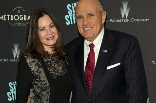 FILE - In this Tuesday, April 12, 2016, file photo, Judith Giuliani, left, and former New York mayor Rudy Giuliani, right, attend the premiere of "Sing Street" at Metrograph, in New York. Giuliani and his third wife, Judith, have reached a settlement in a yearslong court battle that exposed details about their luxurious lifestyle, The New York Times reported on Tuesday, Dec. 10, 2019. (Photo by Andy Kropa/Invision/AP, File)