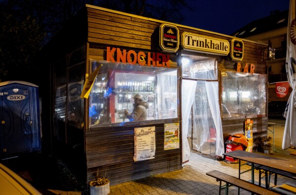 A man stands inside a former water house, a small shop that sprung up in the 19th century to encourage workers to drink affordable water rather than beer or schnapps, that is now a kiosk in Frankfurt, Germany, on Feb. 15, 2025. (AP Photo/Michael Probst)