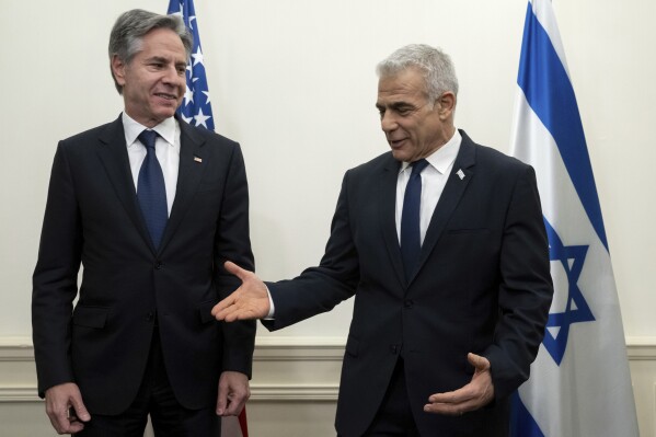 US Secretary of State Antony Blinken, left, meets with Israeli opposition leader Yair Lapid, in Tel Aviv, Israel, on Thursday, Nov. 30, 2023. Blinken is reminding Israeli leaders of the need for Israel to comply with international law as it prosecutes it war against Hamas in Gaza. Blinken also said it is imperative that Israel take great care to avoid civilian casualties if it starts major military operations in southern Gaza, where hundreds of thousands of Palestinians have sought shelter after fleeing their homes in the northern part of the territory.(Saul Loeb/Pool Photo via AP)