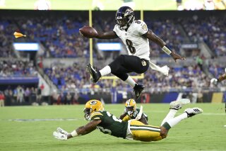 FILE - In this Aug. 15, 2019, file photo, Baltimore Ravens quarterback Lamar Jackson (8) leaps ov...