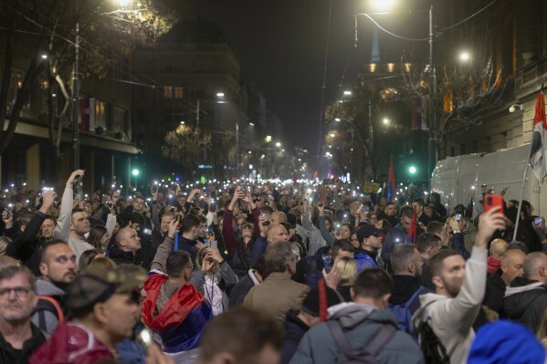 People observe 15 minutes of silence during a massive anti-government rally in Belgrade, Serbia, Saturday, March 15, 2025. (AP Photo/Marko Drobnjakovic)