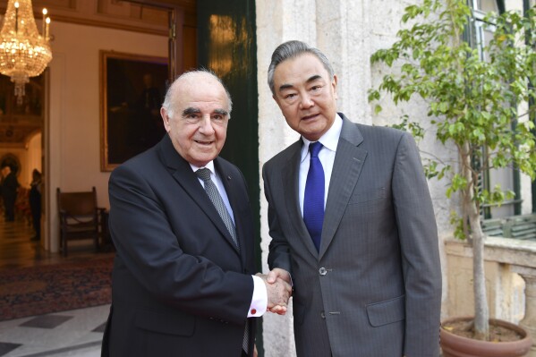 In this photo released by Xinhua News Agency, Chinese Foreign Minister Wang Yi, right, is greeted by Maltese President George Vella at the presidential palace in Valletta, Malta on Sunday, Sept. 17, 2023. China's top foreign policy official is heading to Russia for security talks after two days of meetings with U.S. President Joe Biden's national security advisor over the weekend in Malta. (Lian Yi/Xinhua via AP)