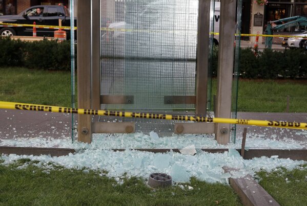 FILE - This Aug. 14, 2017 file photo shows broken glass on the ground near police tape at the New England Holocaust Memorial in Boston. Memorials to Holocaust victims and others dedicated to people of color across the U.S. repeatedly are vandalized, forcing volunteers, cities and universities to spend hundreds of thousands on repairs and security. (AP Photo/Steven Senne, File)