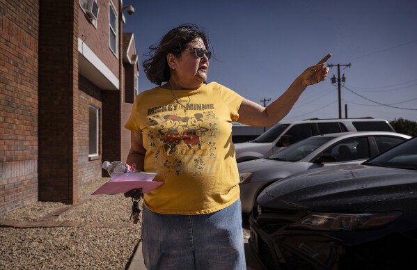 Rosana Colorbio, a resident at the Woodcrest Apartments, talks with the Journal in Las Cruces, N.M., on Saturday, March 22, 2025, as the apartments are located directly across the street from Young Park after Friday night's fatal shooting. (Chancey Bush/The Albuquerque Journal via AP)