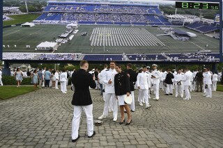 Graduating midshipmen gather under the scoreboard to line up for the U.S. Naval Academy 2024 commissioning and graduation ceremony, Friday, May 24, 2024 in Annapolis, Md. Defense Secretary Lloyd Austin told U.S. Naval Academy graduates Friday that they will be leading future sailors and Marines “through tension and uncertainty,” noting how two graduates from last year were just aboard the USS Carney in the Red Sea, where they helped shoot down missiles and drones. (Paul W. Gillespie/The Baltimore Sun via AP)