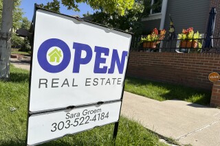 A sign stands outside a home for sale in the Alamo Placits neighborhood Tuesday, Aug. 27, 2024, in central Denver. (AP Photo/David Zalubowski, File)