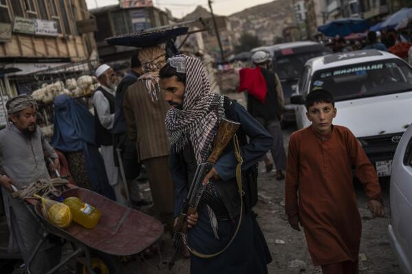 Taliban fighters patrol a market in Kabul's Old City, Afghanistan, Tuesday, Sept. 14, 2021. A month after the fall of Kabul, the question of how the world will get aid to citizens without enriching Afghanistan's Taliban rulers is haunting the country. The stakes have soared for Afghans, who along with the threat of famine and a collapsing health care system face a looming crisis as winter approaches. (AP Photo/Bernat Armangue)