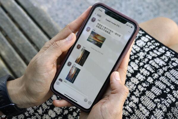 FILE - Sha Zhu, of Washington, shows the app WeChat on her phone, which she uses to keep in touch with family and friends in the U.S. and China, Tuesday Aug. 18, 2020, in Washington.  For months, the Elon Musk has expressed interest in creating his own version of China’s WeChat — a “super app” that does video chats, messaging, streaming and payments — for the rest of the world.. At least, that is, once he's done buying Twitter after months of legal infighting over the $44 billion purchase agreement he signed in April 2022. AP Photo/Jacquelyn Martin)