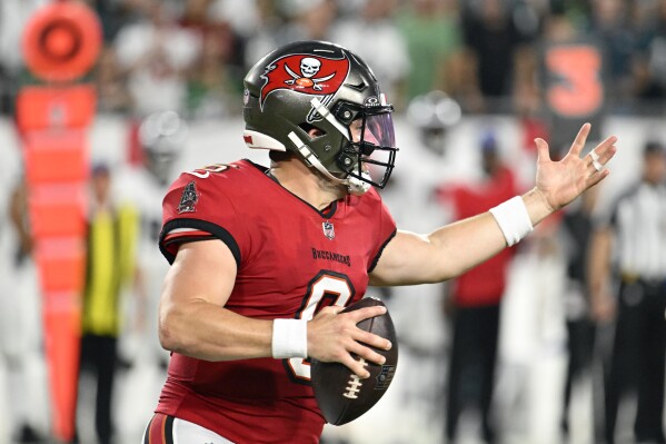 Tampa Bay Buccaneers' Baker Mayfield rolls out during the first half of an NFL football game against the Philadelphia Eagles, Monday, Sept. 25, 2023, in Tampa, Fla. (AP Photo/Jason Behnken)