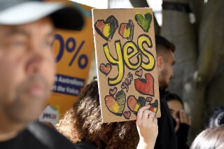 A woman holds a hand-made "Yes" sign as supporters gather at the Redfern Community Centre in Sydney, Monday, Oct. 9, 2023. Australians appear likely to reject the creation of an advocate for the Indigenous population in a referendum outcome that some see as a victory for racism. (Bianca De Marchi/AAP Image via AP)