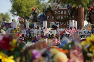 FILE - Crosses, flowers and other memorabilia form a make-shift memorial for the victims of the shootings at Robb Elementary School in Uvalde, Texas, July 10, 2022. The Associated Press and other news organizations are suing officials in Uvalde after months of refusal to publicly release records related to the May 2022 shooting at the elementary school. (AP Photo/Eric Gay, File)