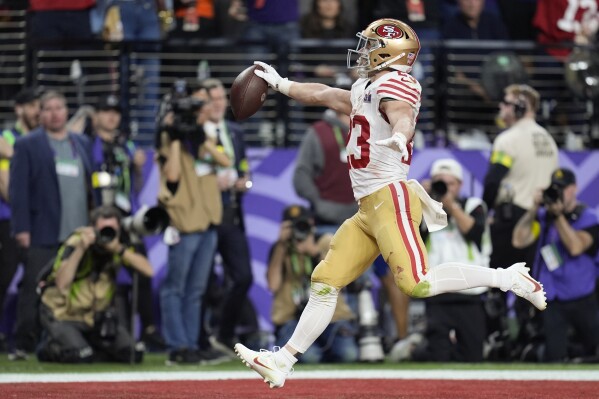 San Francisco 49ers running back Christian McCaffrey (23) scores a touchdown against the Kansas City Chiefs during the first half of the NFL Super Bowl 58 football game Sunday, Feb. 11, 2024, in Las Vegas. (AP Photo/Eric Gay)