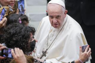 Pope Francis poses for a selfie photo with faithful at the end of his weekly general audience in the Paul VI Hall at the Vatican, Wednesday, Nov. 17, 2021. (AP Photo/Gregorio Borgia)