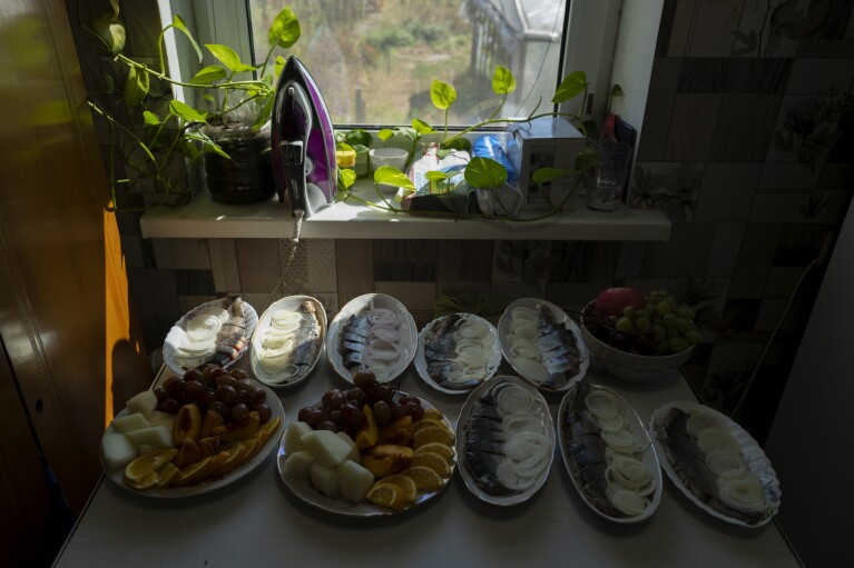 Traditional Ukrainian food sits on the table during the wedding ceremony of blind Ukrainian soldier Ivan Soroka and his wife Vladislava Ryabets, not seen, in the outskirt of Kyiv, Ukraine on Sunday, Sept. 10, 2023. (AP Photo/Bela Szandelszky)