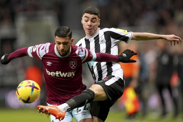 Newcastle United's Miguel Almiron, right and West Ham United's Said Benrahma battle for the ball, during the English Premier League soccer match between Newcastle United and West Ham United, at St. James' Park, in Newcastle upon Tyne, England, Saturday, Feb. 4, 2023. (Owen Humphreys/PA via AP)
