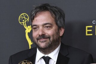 FILE - Adam Schlesinger, winner of the awards for outstanding original music and lyrics for "Crazy Ex Girlfriend," in the press room at the Creative Arts Emmy Awards in Los Angeles on Sept. 14, 2019. An eclectic lineup of musicians is turning out for an online tribute to Adam Schlesinger, the prolific songwriter who died a year ago of COVID-19. Members of the Monkees, R.E.M., Dashboard Confessional and the Black Keys are expected, along with Sean Ono Lennon, Courtney Love, Drew Carey and Rachel Bloom. The ‘musical celebration’ will premiere May 5 on the Rolling Live platform. (Photo by Richard Shotwell/Invision/AP, File)