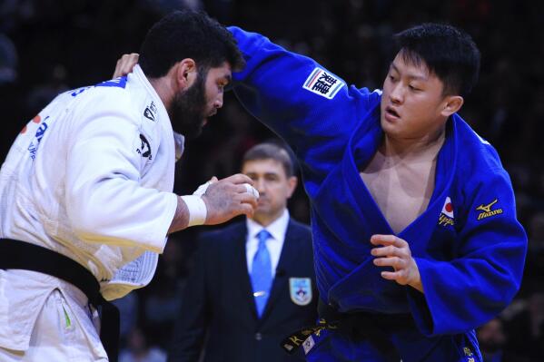 FILE - In this  Sunday, Feb. 7, 2016, file photo, Or Sasson, of Israel, left, competes against Hisayoshi Harasawa, of Japan, during the men's +100 kg final at the Grand Slam Paris 2016 Judo tournament, in Paris. Judo is coming home at the Tokyo Olympics. Hisayoshi Harasawa, who lost to Teddy Riner in the Olympic final in Rio de Janeiro five years ago, was picked for another shot at the games. (AP Photo/Thibault Camus, File)