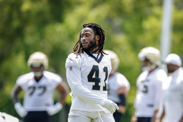 New Orleans Saints running back Alvin Kamara (41) takes off his helmet during the team's NFL mini-camp football practice at Ochsner Sports Performance Center in Metairie, La., Tuesday, June 11, 2024. (Sophia Germer/The Times-Picayune/The New Orleans Advocate via AP)