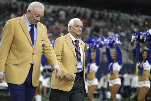 FILE - Hall Of Fame inductee Gil Brandt, right, was presented with his HOF ring by Dallas Cowboys team owner Jerry Jones, left, during a half time ceremony during an NFL football game against the Green Bay Packers in Arlington, Texas, Sunday, Oct. 6, 2019. Gil Brandt, overshadowed by coach Tom Landry and general manager Tex Schramm as part of the trio that built the Dallas Cowboys into “America’s Team” in the 1970s, has died. He was 91. The Pro Football Hall of Fame said Brandt died Thursday morning, Aug. 31, 2023. (AP Photo/Ron Jenkins, File)