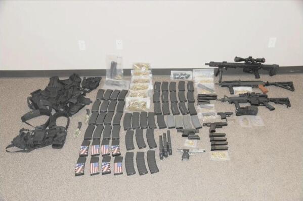 This photo released by the North Dakota Bureau of Criminal Investigation on Wednesday, July 19, 2023, shows the cache of weapons and ammunition that authorities recovered from the car of a man who opened fire on Fargo, N.D., police officers on Friday, July 14. One officer, Jake Wallin, was killed and two others were injured before a fourth officer shot and killed 37-year-old Mohamad Barakat. (North Dakota Bureau of Criminal Investigation via AP)