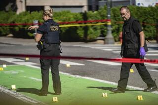 FILE - In this July 17, 2021, file photo, police investigate an overnight fatal shooting in Portland, Ore. In 2021 Portland, Ore., recorded 90 homicides amid a surge in gun violence, shattering the city's previous high of 66 set more than three decades ago. (Mark Graves/The Oregonian via AP, File)