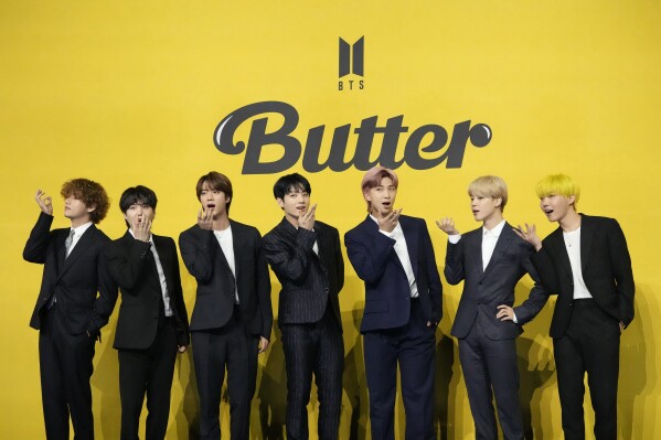 FILE- Members of South Korean K-pop band BTS, V, SUGA, JIN, Jung Kook, RM, Jimin, and j-hope from left to right, pose for photographers ahead of a press conference to introduce their new single "Butter" in Seoul, South Korea, Friday, May 21, 2021. South Korea has recently retaliated for North Korea's trash-carrying balloon launches with propaganda loudspeaker broadcasts at border areas. The South Korean broadcasts reportedly included K-pop sensation BTS’s mega hits like “Butter” and “Dynamite,” weather forecasts and news on Samsung as well as outside criticism on the North’s missile program. (AP Photo/Lee Jin-man, File)