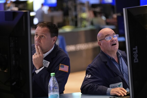 Matthew Cheslock, left, and Anthony Confusione work on the floor at the New York Stock Exchange in New York, Wednesday, April 30, 2025. (AP Photo/Seth Wenig)