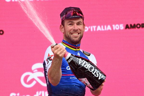 Britain's Mark Cavendish celebrates on the podium after winning the third stage of the Giro d’Italia cycling race, from Kaposvar to Balatonfured, Hungary, Sunday, May 8, 2022. (Gian Mattia D'Alberto/LaPresse via AP)